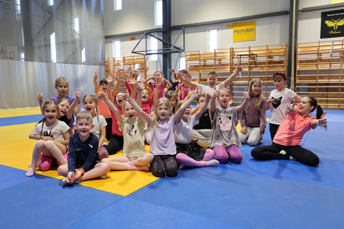 Children and instructors together in a gym